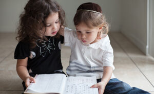 Brother and sister studying the Aleph Bet together