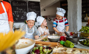 Photo of a group of children having fun during cooking class with a chef